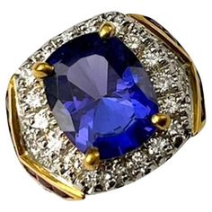 This is an artistic and truly unique ring. This large Tanzanite which weighs 6.25Ct is very deep and saturated in color and is also quite transparent. The addition of rubies to the design adds a creative element that blends seamlessly. This is a substantial ring that definitely makes a statement and will get noticed. Unique Sapphire And Diamond Ring For Formal Occasions, Unique Formal Sapphire Ring With Accent Stones, Bishop Ring, Contemporary Ring, Organic Chemistry, Platinum Ring, Unique Ring, Ruby Ring, Gem Stone