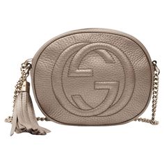 This crossbody bag is made of metallic champagne gold calfskin leather, with a prominent Gucci GG blondie logo stitched on the front. The bag features a polished light brass chain link shoulder strap, and a matching brass-knobbed leather tassel zipper pull. This opens the bag to a natural fiber interior with a patch pocket. Classic discontinued model. Retail Color: champagne gold Material: Pebble leather Model No. 353965 Comes with: dust bag Condition: Excellent. Like new. Never used. Made in It Mini Designer Bags, Gucci Soho, Gucci Purses, Shoulder Strap Bag, Brown Shoulder Bag, Gucci Shoulder Bag, Chain Crossbody Bag, Handbag Straps, Designer Shoulder Bags