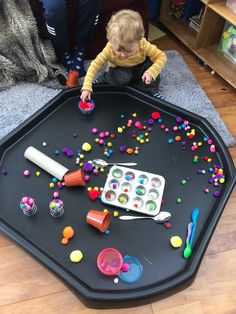 a toddler playing with toys on the floor