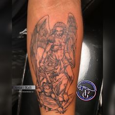 an angel tattoo on the leg of a man