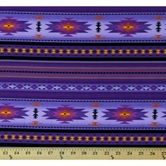 a purple and yellow pattern on fabric with a ruler in the foreground, next to it