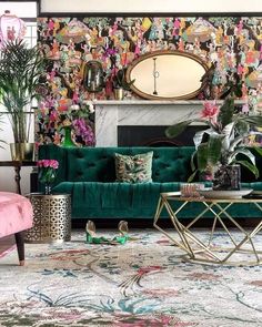 a living room filled with green couches next to a fire place in front of a painting on the wall