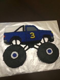 a birthday cake with a monster truck on it