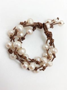 "~ Ready to wear ~ This listing is for ONE leather multi strand Beaded pearl bracelet, your choice of either the black, antique brown or natural brown leather cord. The bracelets shown are approx 8 1/2\" but fit snug on a 6 1/2\" wrist. The bulky pearls are separated with hand knots but slide organically with movement. All natural, genuine materials from the pearls down to the leather. When you order please include how many inches you would prefer your bracelet to be, for all bracelets are made Elegant Adjustable Brown Beaded Bracelets, Elegant Brown Wrap Bracelet As A Gift, Elegant Brown Leather Wrap Bracelet, Elegant Brown Beaded Wrap Bracelet, Brown Leather Bracelet With Round Beads, Elegant Leather Beaded Bracelets As Gift, Hand-strung Brown Leather Bracelet Gift, Brown Hand-strung Leather Bracelet Gift, Elegant Beaded Leather Bracelet