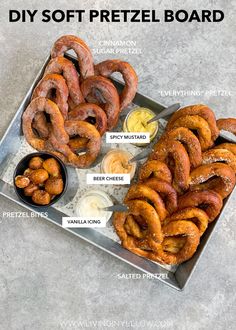 a tray with pretzels and dipping sauces on it, labeled diy soft pretzel board