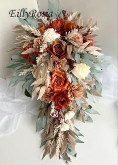 a bridal bouquet made up of flowers and leaves