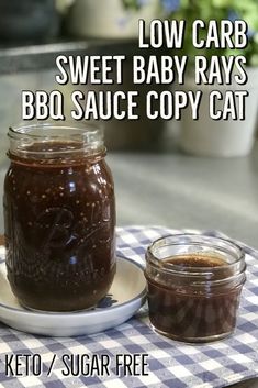 there is a jar of bbq sauce next to a plate with a spoon on it