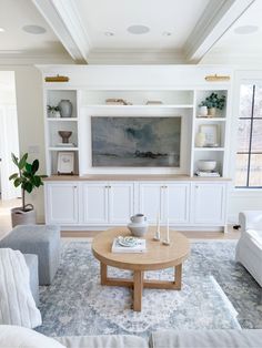 a living room filled with furniture and a painting on the wall above it's coffee table