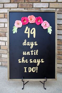 a sign with flowers on it that says, forty days until she says i do