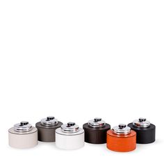 six different colored canisters are lined up in a row