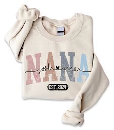 Customization any nicknames, name on sleeve for Nana, Grandma This sweatshirt is perfect to escape the cold. It covers everything from the hips to the neck, allows the person wearing it to stay toasty at all times. Plus, with the side-front pockets, the phone and the wallet can stay warm, too. Suitable for many occasions, such as for Valentine, Christmas, Father's Day, Mother's Day, Birthday,... 8.0 oz., pre-shrunk 50/50 cotton/polyester Blend pill-resistant fleece Two-ply hood with grommets and White Crew Neck Top With Custom Name, Personalized Crew Neck Sweatshirt In Relaxed Fit, Personalized Relaxed Fit Crew Neck Sweatshirt, Custom Name White Crew Neck Sweatshirt, Custom Name Long Sleeve Cotton Sweatshirt, Nana Sweatshirt, Pastel Sweatshirt, Nana Grandma, Pregnancy Announcement Gifts