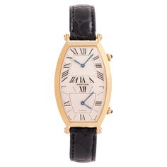 Vintage Cartier Tonneau Dual-Time 18k Yellow Gold Large Size On Cartier Black Alligator Strap and 18k Yellow Gold Deployment Buckle 46mm x 26mm Model # W1502853 Quartz Movement c.1990s Crafted with precision and practicality, the Cartier Tonneau Dual Time watch caters to the jet-setter's lifestyle, allowing for precise timekeeping in two separate zones. Take a moment to transport yourself to a charming café in Paris, sipping espresso as you watch the world go by. With a quick glance at your Tonneau, you effortlessly switch time zones, aware that across the Atlantic, the vibrant lights of Times Square are beginning to glow. Introduced in 1906, the elongated shape nods to the French word "tonneau,” meaning barrel. The 18k rose gold oblong design curves gently with the wrist. Protected by scr Cartier Yellow Gold Evening Watch, Evening Cartier Yellow Gold Watch, Evening Yellow Gold Cartier Watch, Cartier Watches With Subdials For Evening, Classic Formal Watch With Rotating Bezel, Luxury Yellow Gold Watch With Rotating Bezel, Vintage Cartier Watch, Black Alligator, Vintage Timepiece