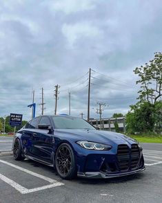 a blue sports car parked in a parking lot