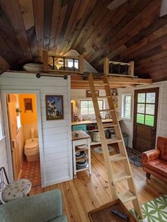 a loft with stairs leading up to the top floor