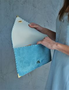 "Soft Symmetria Clutch in jeans blue. The perfect bag for all occasions! Ideal for cocktail and parties or for business meetings depending the size you choose. It comes in two sizes, small and large. You can use it as a chic briefcase for your work or as a modern large clutch for a night out. This adorable large clutch is handmade out of a genuine, lux Italian jeans blue suede leather. -Small size fits all your essentials, wallet, keys, mobile, cosmetics etc. -Large size fits a 15\" laptop, ipad Blue Envelope Bag For Daily Use, Blue Rectangular Shoulder Bag With Laptop Sleeve, Blue Rectangular Clutch With Removable Pouch, Chic Blue Everyday Clutch, Blue Envelope Clutch For Everyday Use, Blue Leather Chic Clutch, Blue Chic Leather Clutch, Formal Blue Envelope Clutch, Blue Pouch Clutch For Everyday Use