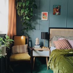 a bed room with a neatly made bed next to a night stand and two chairs