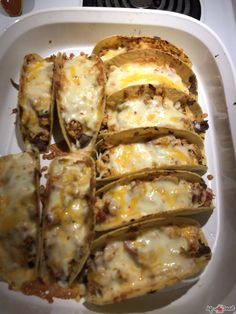 some food is in a white dish on a stove top and ready to be eaten