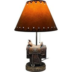 a lamp with a horse on it and a brown shade over the top of it