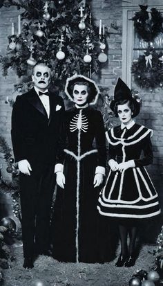 an old black and white photo of two people in halloween costumes