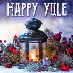 a lantern and christmas decorations with the words happy yule