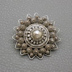 "A wonderful quality antique star-shaped Dutch Button sterling silver filigree pin with lots of character. This Victorian style brooch is hand crafted Holland in in early 1900's in old filigree technique, so called Zeeuwse Knoop (\"Dutch button\"). A collectible piece of traditional Dutch heritage jewelry! The brooch will be shipped in a gift box. The brooch measures almost 1 1/2 inches (3.6 cm) in diameter Weight: 7.7 grams Original trombone clasp closure The brooch was professionally tested fo Traditional Dutch Jewelry, Vintage Pendant Brooches With Intricate Design, Antique Brooches With Intricate Design, Antique Round Brooch With Intricate Design, Vintage Filigree Brooches For Ceremonial Occasions, Antique Round Brooches With Intricate Design, Vintage Filigree Pendant Brooch, Vintage Filigree Pendant Brooches, Vintage Brooches With Intricate Design For Ceremonial Use