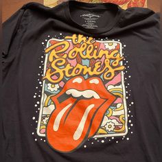 a black shirt with the rolling stones on it