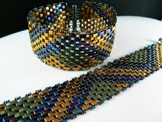 two bracelets sitting next to each other on a table