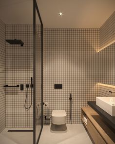 a bathroom with a toilet, sink and shower stall in it's center area