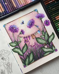 a drawing with purple flowers and green leaves in front of colored pencils on a table