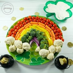 a plate with cauliflower, broccoli, carrots and other vegetables on it