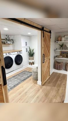 an open door leading to a washer and dryer in a room with wooden floors