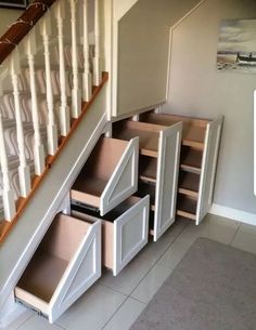 an under stair storage unit with drawers underneath the stairs