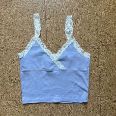 White Crop Tank Top With Lace And Criss-Cross V-Neck. Fabrics: 100% Cotton Measurements: 17" (44 Cm) Length, 12" (31 Cm) Bust Made In: Italy Nwot Casual V-neck Crop Top With Lace Trim, Light Blue V-neck Camisole For Spring, Purple Lace Trim Top For Spring, Fitted Purple Top With Lace Trim, Blue Camisole Top With Lace Trim, Blue Lace Trim Camisole Top, Lavender Fitted V-neck Tops, Fitted Purple V-neck Crop Top, Fitted V-neck Purple Crop Top