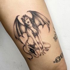 a woman with a dragon tattoo on her leg