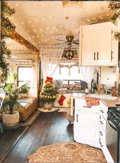 the interior of a camper with christmas lights on the ceiling and decorations hanging from the ceiling