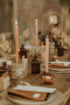 the table is set with candles and place settings