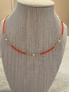 Beautiful dainty beaded necklace made with orange and gold seed beads and glass pearls Cheap Orange Necklaces With Letter Beads, Orange Seed Bead Necklace, Orange Beaded Jewelry, Orange Single Strand Beaded Necklace With Round Beads, Orange Single Strand Beaded Necklace, Adjustable Orange Beaded Chain Jewelry, Adjustable Orange Single Strand Beaded Necklace, Adjustable Orange Beaded Necklace With Tiny Beads, Orange Tiny Beads Necklace For Gift