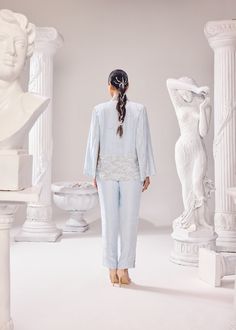 The Audrey Jacket Pant set is a 'bliss of summer air', with intricatly hand embroidered pearl detail with other fine materials all over the jacket and side seam of the pants. This ensemble has a 3D net detailing complimenting linear artwork perfectly juxtaposed together exhibiting impeccable couture craftsmanship. This outfit is a perfect fit to dance away the cocktail night or hit the reception party! Colour: Ice Melt Material: Opara- jacket, Opara- pants No of components: 3 Surface Ornamentation: Hand Embroidery Care Instructions: Dry Clean Shipping Time: 3-4 weeks Spring Embellished Fitted Pant Set, Fitted Embellished Pant Set For Spring, Spring Silk Pant Set With Long Sleeves, Spring Embellished Long Sleeve Pant Set, Embellished Long Sleeve Pant Set For Spring, Spring Silk Fitted Pant Set, Embellished Pant Set For Spring Wedding, Embellished Pant Set For Wedding, Spring Wedding Embellished Pant Set