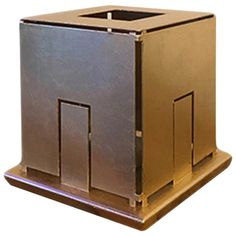 a large metal box sitting on top of a wooden stand