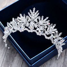 For winter brides, a touch of silver and sparkle is very much en vogue. It’s also an easy way to create a seasonal bridal look with a cheerful winter wonderland style, and this delicate tiara does just that. This beautiful bridal tiara is adorned with intricately faceted rhinestone crystals that capture the light from every angle with a perfectly translucent appeal. The rhodium plating enhances the intricate detailing and conveys a modern take on old elegance. Height: 2.4" (approx. 6.2cm); Diame Crystal Crown Tiaras, Bride Crown, Crystal Bridal Tiaras, Beautiful Tiaras, Floral Accessories Hair, Tiara Hairstyles, Headpiece Hairstyles, Headpiece Jewelry, Hair Jewelry Wedding