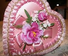 a pink heart shaped box with flowers on it