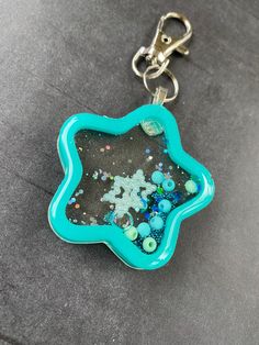 a keychain that has been made to look like a flower with beads on it