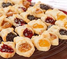 many small pastries are arranged on a platter