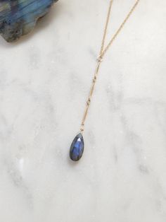 Beautiful Labradorite Waterfall Necklace. Always a gorgeous and magical gemstone! Wear this with a V neck or over a t-shirt for a more casual look. The length of the drop from the little center circle down to the bottom of the stone is just over 2 1/2 in. The chain on the drop is a beautiful bar chain. Each Labradorite is unique and will slightly vary as they are natural. Some will have more of a blue color and others may be more green, yellowish-green, purple-blue, and silverish. If you have a Waterfall Necklace, Yellowish Green, Beautiful Bars, Earring Necklace, Labradorite, Gold Filled, Casual Looks, Blue And Purple, Blue Color