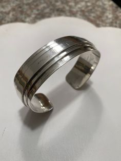 "Offered for your consideration : Vintage Yale Sterling Silver modernist mid century cuff bracelet, circa 1960's. This beauty is in in very good condition, light surface wear from use, free from damage. It measures approximately 2.75\" across, approximately 7\" inner circumference & .75\" wide.... It weighs a hefty 2.5 oz./ 70.87 grams. Signed Sterling by Yale inside the cuff. Gorgeous & it would make a lovely Gift idea! Securely packaged for Free Priority shipping If you get a chance to Modern Metal Cuff Bracelet For Formal Occasions, Modernist Sterling Silver Adjustable Bracelet For Formal Occasions, Modernist Polished Sterling Silver Bangle, Modern Metal Round Cuff Bracelet, Modern Round Metal Cuff Bracelet, Vintage Wide Band Bracelet For Formal Occasions, Vintage Cuff Bangle With Polished Finish, Modernist Polished Bangle Bracelets, Modernist Bangle Bracelet With Polished Finish