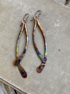 Solid copper hand-hammered into curving drops have been flame-painted with a lovely rainbow pattern.  These earrings are lightweight despite their size.Color will appear brighter in outdoor lighting. 4” drop from hypoallergenic niobium earwires Handmade in NY Earwires Handmade, Hammered Copper Earrings, Brass Hoop Earrings, Painted Earrings, Copper Rose, Large Hoop Earrings, Jewelry Making Tutorials, Earrings Drop, Jewelry Repair