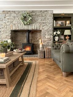 a living room filled with furniture and a fire place in the middle of it's wall