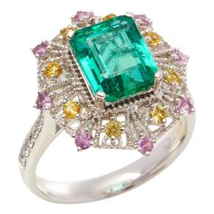 This ring designed by David Jerome is from his private collection and features one Emerald cut Emerald sourced in the chivor mine in Columbia totalling 3.03cts. Set with a mix of round brilliant cut Diamonds, pink and yellow Sapphires totalling 0.78cts combined. Mounted in platinum. Ring size UK N, EU size 54, USA size 6 1/2. David prides himself in only sourcing the finest and most exclusive gemstones whose natural beauty and colour enhance the settings he creates for each piece. These exclusive designs offer buyers a unique opportunity to own the kind of jewellery usually reserved for the finest and most exclusive brands in the world. A real legacy for the future. Sapphire Cluster Ring, Square Stone, Jewels Rings, Contemporary Ring, Royal Jewels, Platinum Ring, Pretty Rings, Vintage Jewels, Pink And Yellow