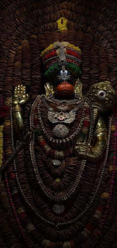 an ornately decorated statue is shown in this artistic photo, with gold accents and jewels