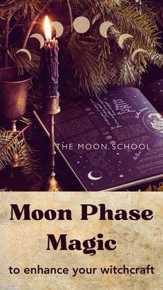 the moon phase magic book with a lit candle and christmas tree in front of it